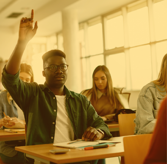 Student raising his arm to answer speak while in a classroom