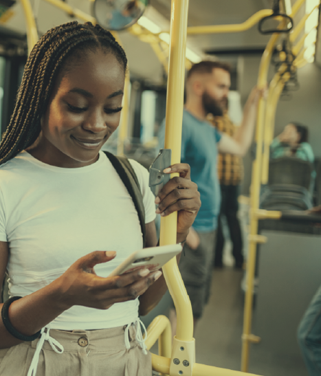 Teen girl on her phone enjoying a bus ride on her way to work.